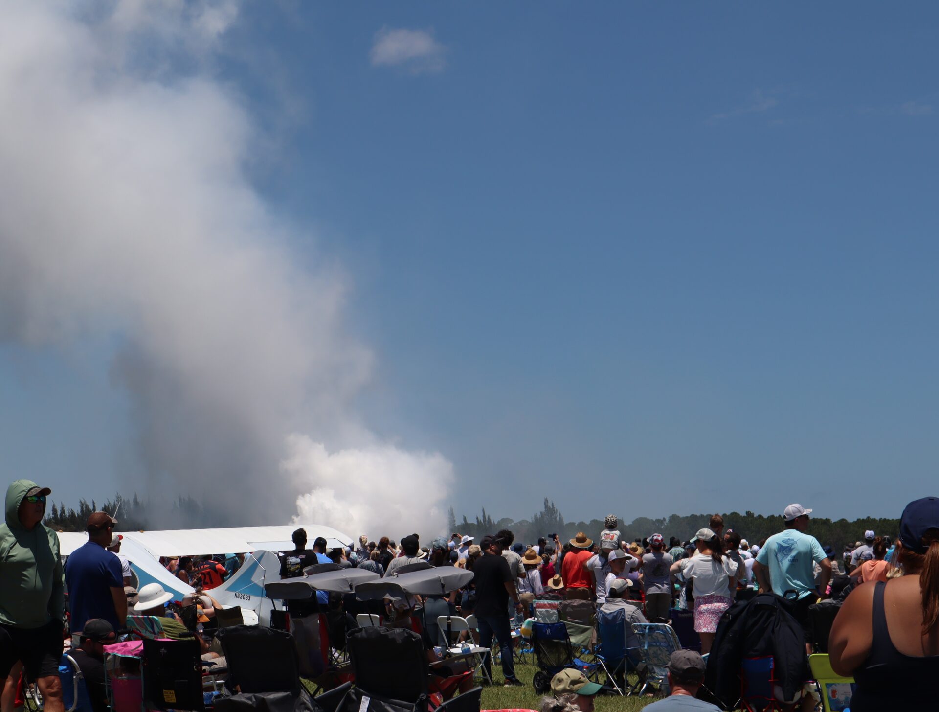 Audience in front of a white smoke cloud